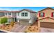 Two-story home featuring neutral stucco, stone accents, and a two-car garage at 5016 Kaslo Ave, Las Vegas, NV 89139