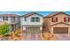 Two-story home featuring neutral stucco, stone accents, and a two-car garage at 5016 Kaslo Ave, Las Vegas, NV 89139