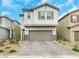 Charming two-story home featuring a stone-accented facade and a spacious two-car garage with a brick driveway at 5016 Kaslo Ave, Las Vegas, NV 89139