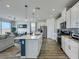 Modern kitchen with stainless steel appliances, a kitchen island, and a view into the living and dining areas at 5016 Kaslo Ave, Las Vegas, NV 89139