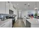 Bright kitchen featuring a center island, white cabinets, and stainless steel appliances at 5016 Kaslo Ave, Las Vegas, NV 89139