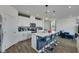 Bright kitchen showcases a central island with barstool seating, white cabinets, and modern pendant lighting at 5016 Kaslo Ave, Las Vegas, NV 89139