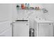 Well-organized laundry room with modern washer and dryer units and shelving for supplies at 5016 Kaslo Ave, Las Vegas, NV 89139