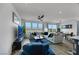 Bright living room with a comfy sectional, coffee table, and views of dining room and kitchen at 5016 Kaslo Ave, Las Vegas, NV 89139