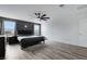 Spacious main bedroom with wood-look flooring, ceiling fan, and neutral color scheme at 5016 Kaslo Ave, Las Vegas, NV 89139