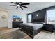 Modern main bedroom features a ceiling fan, grey color palette, and ample natural light from the windows at 5016 Kaslo Ave, Las Vegas, NV 89139