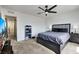 Modern main bedroom features a grey bed, dark furnishings, and a view into another room at 5016 Kaslo Ave, Las Vegas, NV 89139