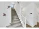 Carpeted staircase with white railings leads to the upper level, accented by modern wall decorations at 5016 Kaslo Ave, Las Vegas, NV 89139