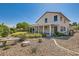 Backyard featuring a covered patio, desert landscaping, and lush green grass, creating a perfect outdoor oasis at 5044 Signal Dr, Las Vegas, NV 89130