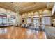 A spacious ballroom featuring a hardwood floor, chandelier, and plenty of natural light from the many large windows at 5044 Signal Dr, Las Vegas, NV 89130