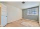 Bright bedroom with a large window fitted with white shutters and a door with built-in shelving at 5044 Signal Dr, Las Vegas, NV 89130
