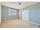 Bedroom features blue walls, shuttered windows, and double door closet for storage at 5044 Signal Dr, Las Vegas, NV 89130