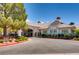 View of the community clubhouse and Pro Shop with golf carts parked out front at 5044 Signal Dr, Las Vegas, NV 89130