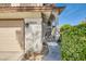 Shot of front of house highlighting the two car garage, stucco siding, desert landscaping and front door at 5044 Signal Dr, Las Vegas, NV 89130