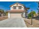 Charming two-story home boasts a spacious driveway, beautiful lawn, and well-maintained landscaping at 5044 Signal Dr, Las Vegas, NV 89130