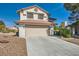 Two-story home featuring a tile roof, a spacious driveway, and a beige two car garage in a well maintained neighborhood at 5044 Signal Dr, Las Vegas, NV 89130