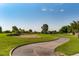 Scenic view of golf course with lush green fairway, mature trees, and blue sky at 5044 Signal Dr, Las Vegas, NV 89130