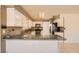 Well-lit kitchen featuring granite countertops, white cabinets, and stainless-steel appliances at 5044 Signal Dr, Las Vegas, NV 89130