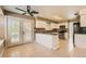 Open kitchen featuring granite countertops, white cabinets, and direct access to the backyard at 5044 Signal Dr, Las Vegas, NV 89130