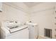 Modern laundry room featuring a front load washer and dryer set at 5044 Signal Dr, Las Vegas, NV 89130