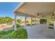 Covered patio offers an inviting spot to enjoy the outdoors, complete with ceiling fans and views of the landscaped backyard at 5044 Signal Dr, Las Vegas, NV 89130