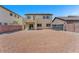 Expansive backyard featuring a gravel ground cover, partial fencing, and a covered patio area at 5060 Blue Rose St, North Las Vegas, NV 89081