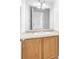 Bright bathroom vanity with wood cabinets and chrome faucet at 5060 Blue Rose St, North Las Vegas, NV 89081