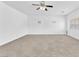 Expansive bonus room with neutral carpet, ample space, and lots of light from windows at 5060 Blue Rose St, North Las Vegas, NV 89081