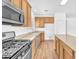 Bright kitchen featuring wood cabinets and stainless steel appliances at 5060 Blue Rose St, North Las Vegas, NV 89081