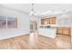 Bright kitchen featuring an island, wood cabinets, and a sliding glass door at 5060 Blue Rose St, North Las Vegas, NV 89081