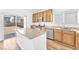 Bright kitchen featuring an island, wood cabinets, and stainless steel appliances at 5060 Blue Rose St, North Las Vegas, NV 89081