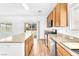 Bright kitchen featuring wood cabinets, an island, and stainless steel appliances at 5060 Blue Rose St, North Las Vegas, NV 89081