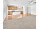 Open-concept living room with a mix of carpet and hardwood flooring, and an eat-in kitchen at 5060 Blue Rose St, North Las Vegas, NV 89081