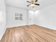 Bright living room with hardwood floors, a ceiling fan, and a window at 5060 Blue Rose St, North Las Vegas, NV 89081