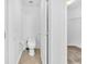 Convenient toilet room featuring tile floors, a toilet, and a door to a closet at 5060 Blue Rose St, North Las Vegas, NV 89081