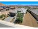 Aerial view of home with a three-car garage, mature landscaping, and desert surroundings at 54 Mirage View Dr, Henderson, NV 89011
