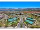 Beautiful community aerial showcasing the recreation center with pools and tennis courts with lake views at 54 Mirage View Dr, Henderson, NV 89011