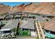 Aerial view featuring a well manicured backyard with outdoor seating, landscaping and mountain views at 54 Mirage View Dr, Henderson, NV 89011