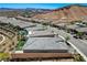 Aerial view featuring a well manicured backyard with outdoor seating, landscaping and mountain views at 54 Mirage View Dr, Henderson, NV 89011