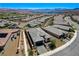 Community aerial view showcases modern homes with desert landscaping and a lake view, set against a mountain backdrop at 54 Mirage View Dr, Henderson, NV 89011