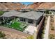 Aerial shot showcasing a backyard with a firepit, outdoor seating, a small garden, and modern desert landscaping at 54 Mirage View Dr, Henderson, NV 89011