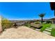 Expansive backyard with turf,sandbox,desert views, and thoughtfully placed seating areas at 54 Mirage View Dr, Henderson, NV 89011