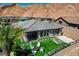 Aerial shot showcasing a backyard with a firepit, outdoor seating, a small garden and desert landscaping at 54 Mirage View Dr, Henderson, NV 89011