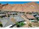 A backyard offers an outdoor seating area, desert landscaping, mountain views, and a modern architectural design at 54 Mirage View Dr, Henderson, NV 89011