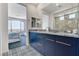 Contemporary bathroom with double sinks, modern tile flooring, and bedroom access with mountain view at 54 Mirage View Dr, Henderson, NV 89011