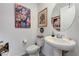 Stylish half bathroom boasting unique tile flooring and artistic decor at 54 Mirage View Dr, Henderson, NV 89011