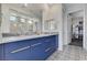 Elegant bathroom with a double vanity, modern mirrors, beautiful patterned tile floor, and walk-in shower at 54 Mirage View Dr, Henderson, NV 89011
