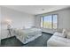 Bedroom with large window offering mountain views, carpeted floor, seating area and side tables at 54 Mirage View Dr, Henderson, NV 89011