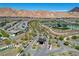 Wide aerial shot of the community entrance, showing the gate and the lush landscaping at 54 Mirage View Dr, Henderson, NV 89011