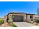 Attractive one-story home with gray garage door, paved driveway, and tasteful landscaping, presenting a welcoming curb appeal at 54 Mirage View Dr, Henderson, NV 89011